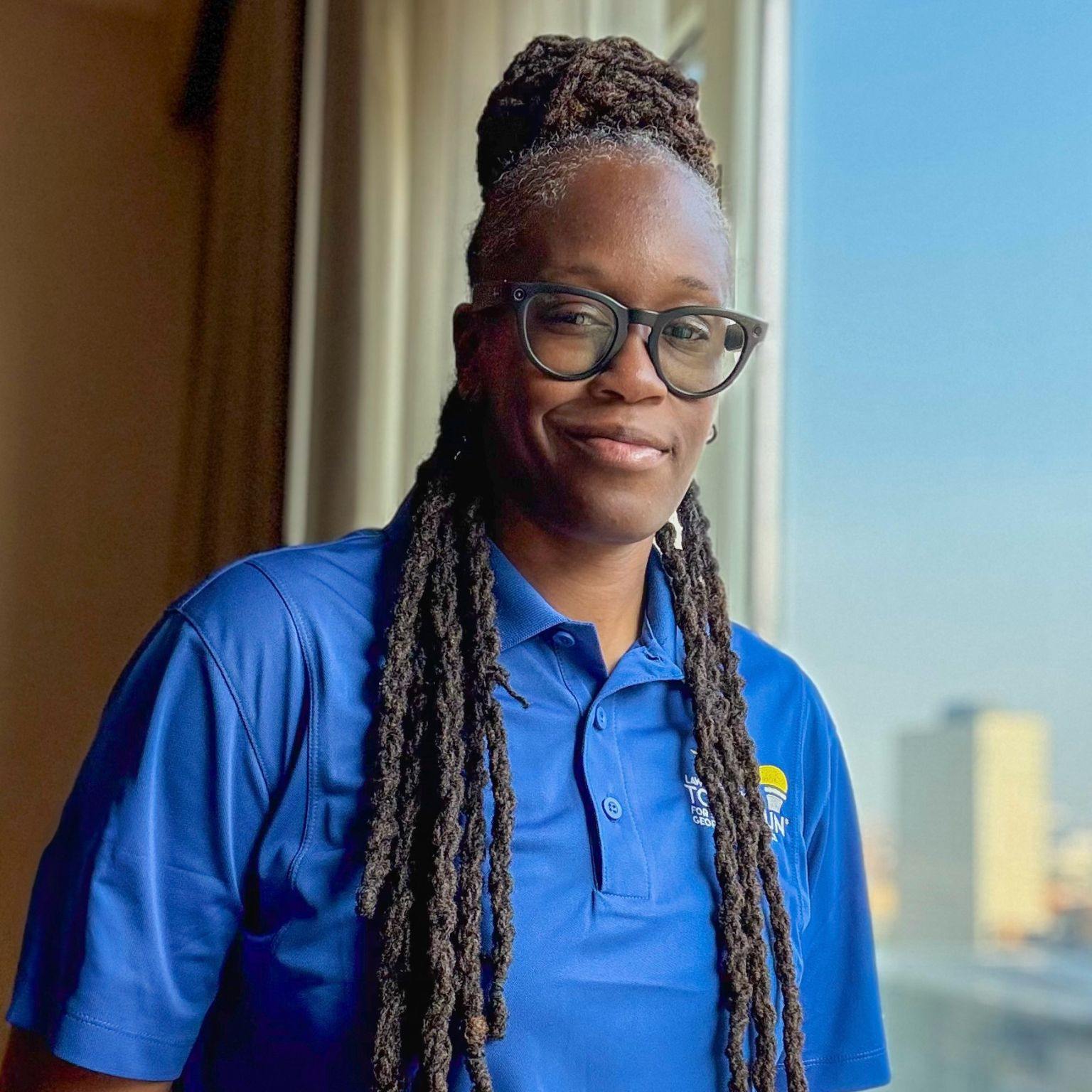 Carlai Moore, founder of Tables & Bridges, in a professional field portrait.